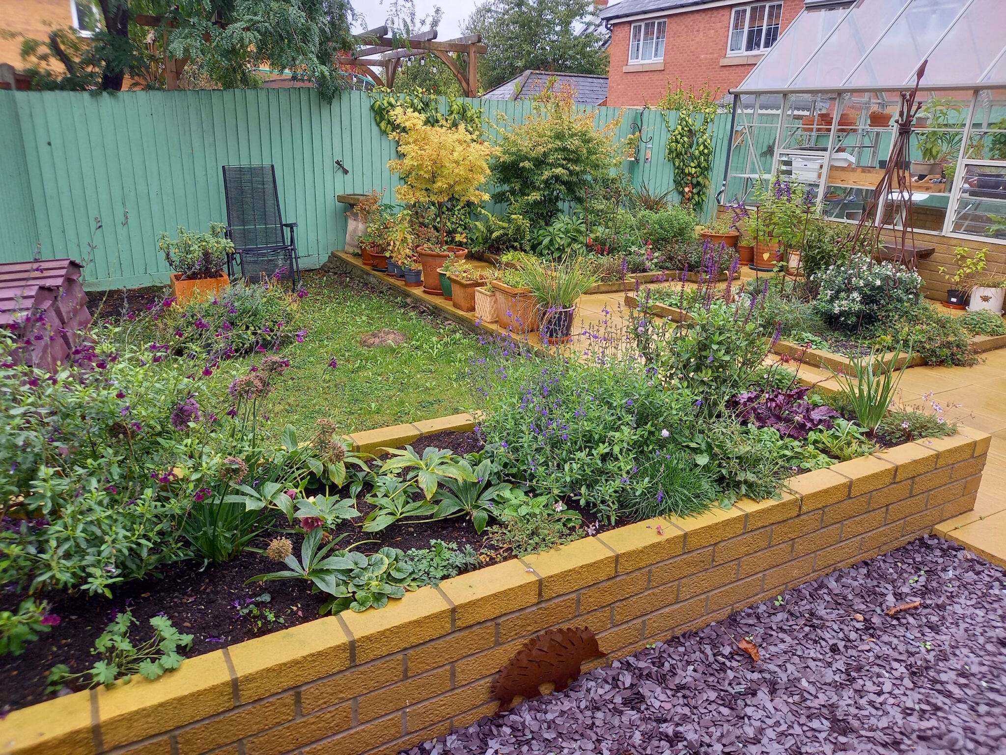 Back garden 3: three years later and filled with brick raised beds and a greenhouse. There is one area of lawn, which will eventually become more raised beds.